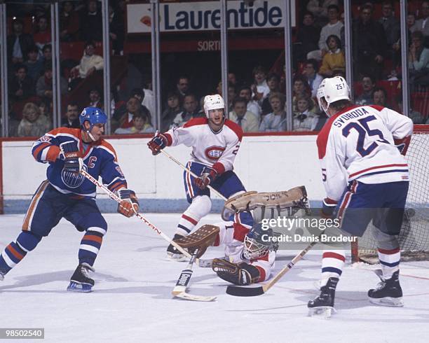 Wayne Gretzky of the Edmonton Oilers skates against goaltender Richard Sevigny of the Montreal Canadiens in the 1980's at the Montreal Forum in...