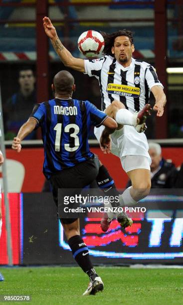Inter Milan's Brazilian defender Maicon jumps with Juventus Brazilian forward Amauri Carvalho de Oliveira prior to score against Juventusagainst...