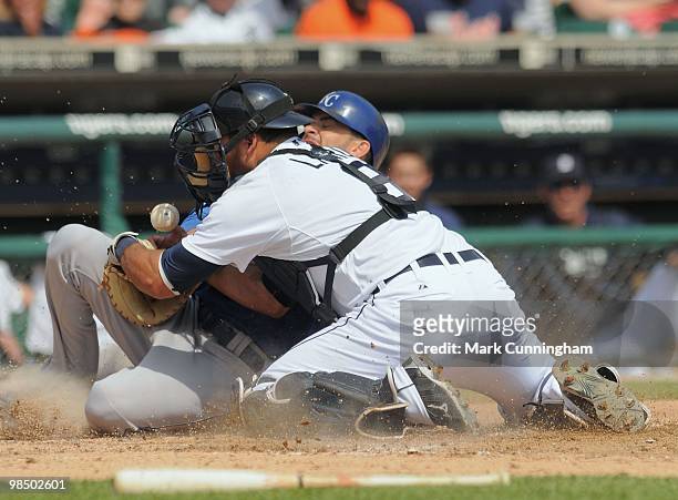 David DeJesus of the Kansas City Royals slides safely into home as Gerald Laird of the Detroit Tigers looks for the baseball during the game at...