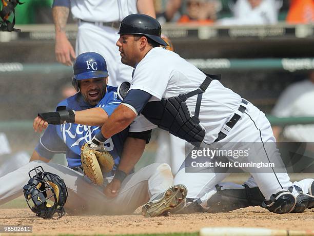 David DeJesus of the Kansas City Royals slides safely into home as Gerald Laird of the Detroit Tigers looks for the baseball during the game at...