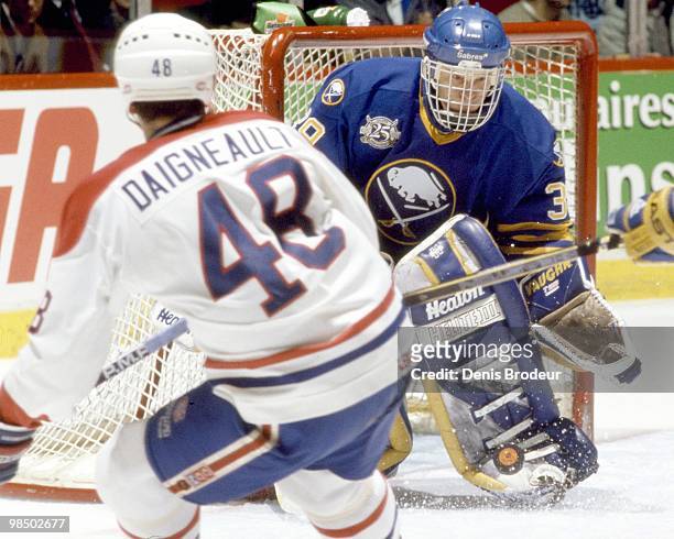 Goaltender Dominik Hasek of the Buffalo Sabres protects the net against Jean-Jacques Daigneault of the Montreal Canadiens in the 1990's at the...