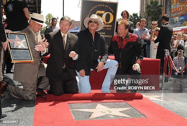 Country music performer Alan Jackson is flanked by Hollywood Chamber of Commerce President Leron Gubler and radio personality Shawn Pratt at the...