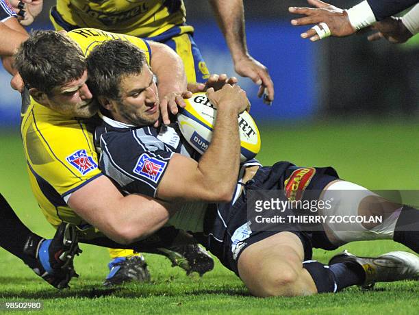 Castres French hooker is tackled by Clermont's French prop Vincent Debaty during the French Top 14 rugby union match Clermont versus Castres at the...