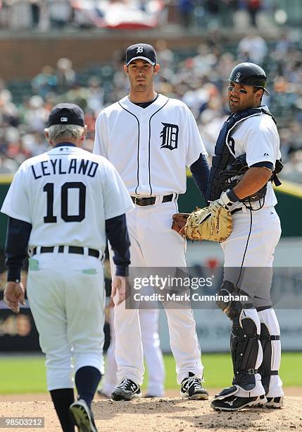 Rick Porcello and Gerald Laird of the Detroit Tigers look on as manager Jim Leyland walks towards the mound against the Kansas City Royals during the...