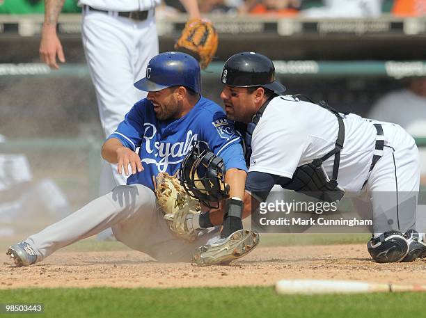 David DeJesus of the Kansas City Royals slides safely into home as Gerald Laird of the Detroit Tigers applies the tag during the game at Comerica...