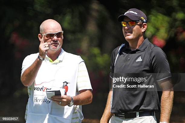 Greg Owen of England chats with his caddie on the 13th hole during the second round of the Verizon Heritage at the Harbour Town Golf Links on April...