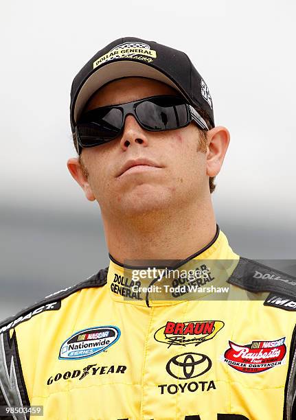 Brian Scott, driver of the Dollar General Toyota, stands on the grid during qualifying for the NASCAR Nationwide Series O'Reilly Auto Parts 300 at...