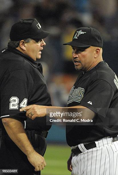 Manager Fredi Gonzalez of the Florida Marlins speaks with umpire Jerry Layne during a MLB game against the Los Angeles Dodgers at Sun Life Stadium on...