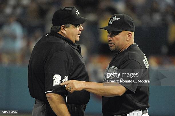 Manager Fredi Gonzalez of the Florida Marlins speaks with umpire Jerry Layne during a MLB game against the Los Angeles Dodgers at Sun Life Stadium on...