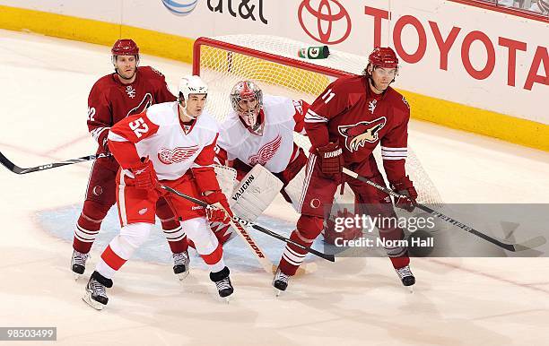 Jonathan Ericsson of the Detroit Red Wings fights for position with Lee Stempniak of the Phoenix Coyotes as Red Wings Goaltender Jimmy Howard tries...