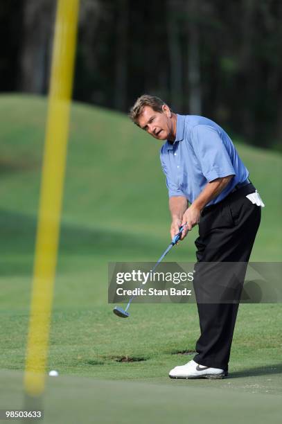 Former NFL quarterback and sports announcer Joe Theismann hits a putt on the 16th green during the first round of the Outback Steakhouse Pro-Am at...