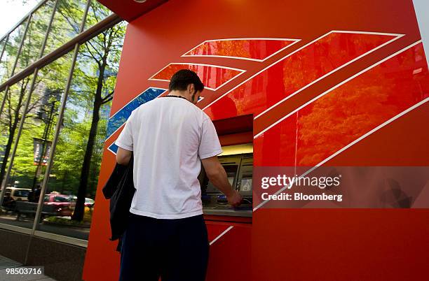 James Velazquez uses a Bank of America Corp. Automated teller machine in Charlotte, North Carolina, U.S., on Friday, April 16, 2010. Bank of America...