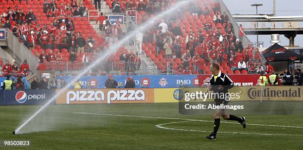 Referee warms just as the sprinkler system kicks in before action between Toronto FC and Philadelphia Union at BMO Field April 15, 2010 in Toronto,...