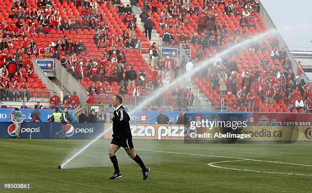 Referee warms just as the sprinkler system kicks in before action between Toronto FC and Philadelphia Union at BMO Field April 15, 2010 in Toronto,...