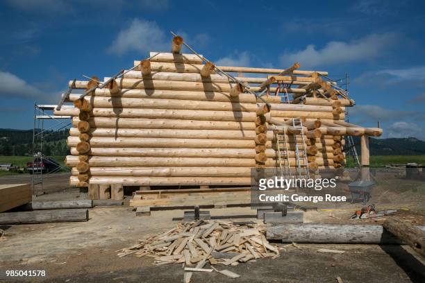Log home made of custom-cut cedar trees is being constructed at the Montana Log Homes manufacturing site before being delivered and reconstructed at...