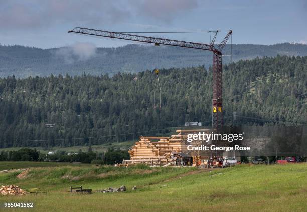 Log home made of custom-cut cedar trees is being constructed at the Montana Log Homes manufacturing site before being delivered and reconstructed at...