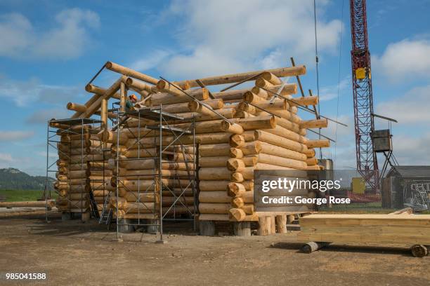 Log home made of custom-cut cedar trees is being constructed at the Montana Log Homes manufacturing site before being delivered and reconstructed at...