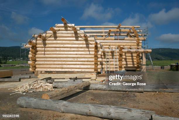 Log home made of custom-cut cedar trees is being constructed at the Montana Log Homes manufacturing site before being delivered and reconstructed at...