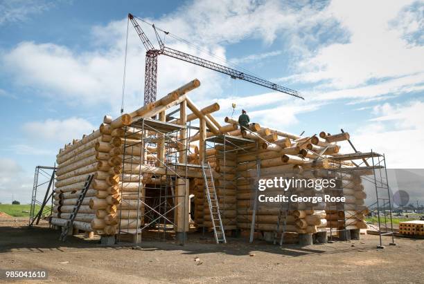 Log home made of custom-cut cedar trees is being constructed at the Montana Log Homes manufacturing site before being delivered and reconstructed at...