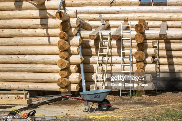 Log home made of custom-cut cedar trees is being constructed at the Montana Log Homes manufacturing site before being delivered and reconstructed at...