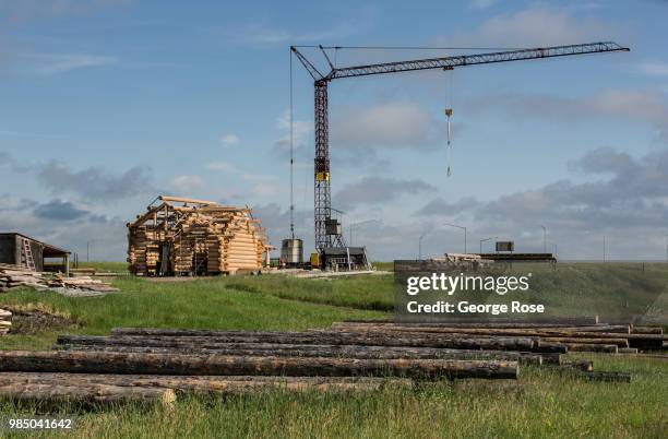 Log home made of custom-cut cedar trees is being constructed at the Montana Log Homes manufacturing site before being delivered and reconstructed at...