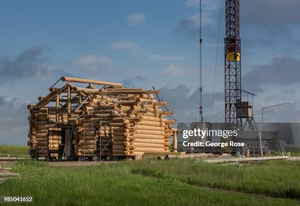 Log home made of custom-cut cedar trees is being constructed at the Montana Log Homes manufacturing site before being delivered and reconstructed at...