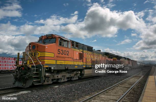 Freight train hauling oil tankers loaded with crude oil heads west through the this downtown transcontinental railroad hub on June 22 in Whitefish,...