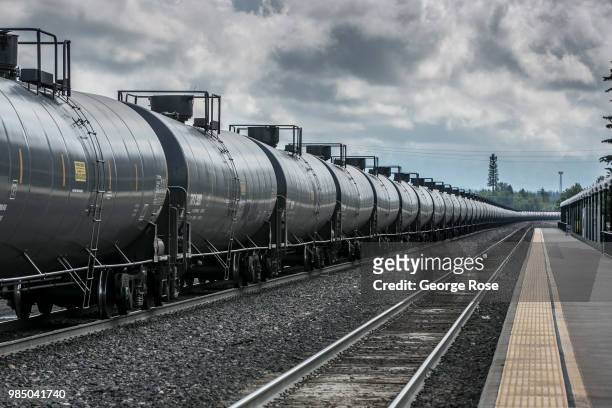 Freight train hauling oil tankers loaded with crude oil heads west through the this downtown transcontinental railroad hub on June 22 in Whitefish,...