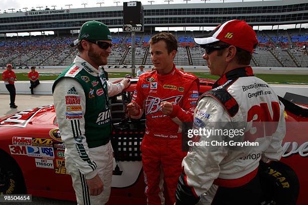 Dale Earnhardt Jr., driver of the National Guard/AMP Energy Chevrolet, speaks to Kasey Kahne, driver of the Budweiser Ford, and Greg Biffle, driver...