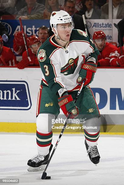 Marek Zidlicky of the Minnesota Wild plays the puck against the Detroit Red Wings during their NHL game on March 11, 2010 at Joe Louis Arena in...