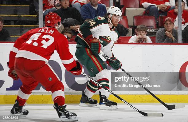 Martin Havlat of the Minnesota Wild looks to pass the puck against Darren Helm of the Detroit Red Wings during their NHL game on March 11, 2010 at...