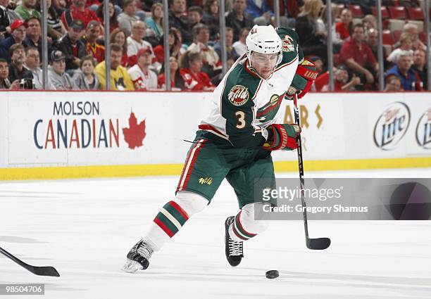 Marek Zidlicky of the Minnesota Wild skates with the puck against the Detroit Red Wings during their NHL game on March 11, 2010 at Joe Louis Arena in...
