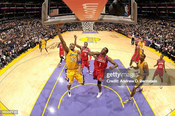 Kobe Bryant of the Los Angeles Lakers goes to the basket against Andre Iguodala and Samuel Dalembert of the Philadelphia 76ers during the game on...
