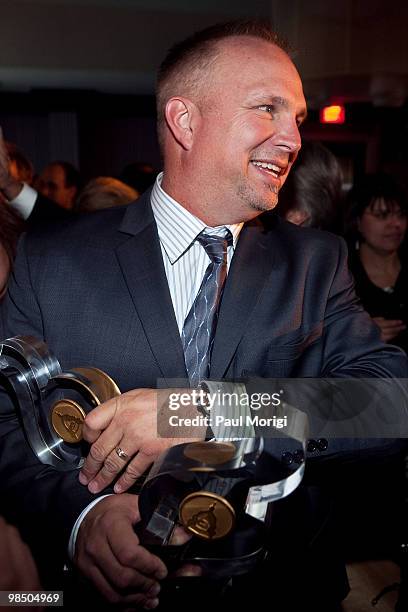 Musician and honoree Garth Brooks with his award at the GRAMMYs on the Hill awards at The Liaison Capitol Hill Hotel on April 14, 2010 in Washington,...