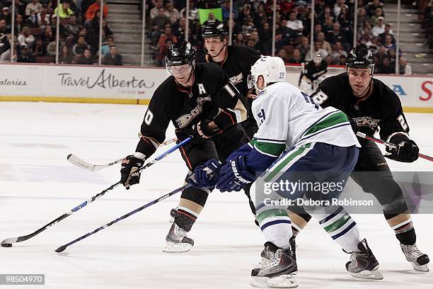 Corey Perry of the Anaheim Ducks handles the puck against Aaron Rome of the Vancouver Canucks during the game on April 2, 2010 at Honda Center in...
