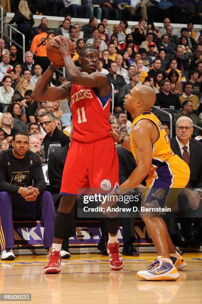 Jrue Holiday of the Philadelphia 76ers posts up against Derek Fisher of the Los Angeles Lakers during the game on February 26, 2010 at Staples Center...