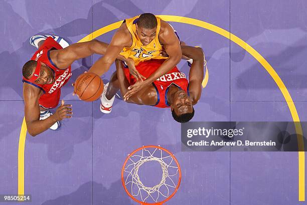 Andrew Bynum of the Los Angeles Lakers goes to the basket against Elton Brand and Samuel Dalembert of the Philadelphia 76ers on February 26, 2010 at...