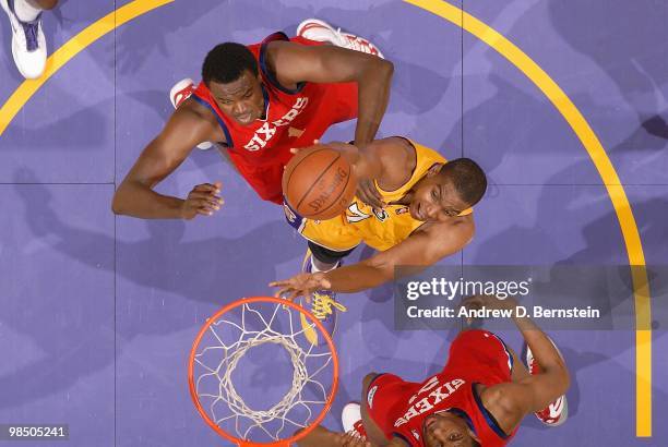 Andrew Bynum of the Los Angeles Lakers goes to the basket against Samuel Dalembert and Thaddeus Young of the Philadelphia 76ers on February 26, 2010...