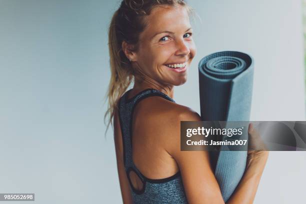 en bonne santé vivant-jeune femme avec tapis d’yoga - yoga pose photos et images de collection