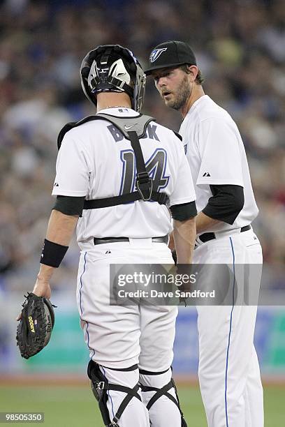 Brian Tallet of the Toronto Blue Jays talks with catcher John Buck during the game against the Chicago White Sox at the Rogers Centre on April 12,...