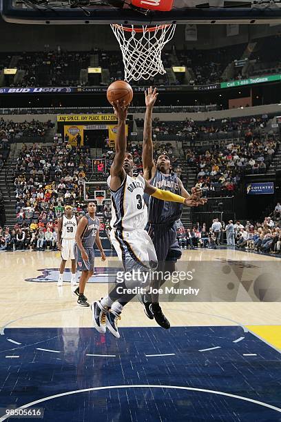 Mayo of the Memphis Grizzlies lays up a shot against Tyrus Thomas of the Charlotte Bobcats during the game on February 26, 2010 at FedExForum in...