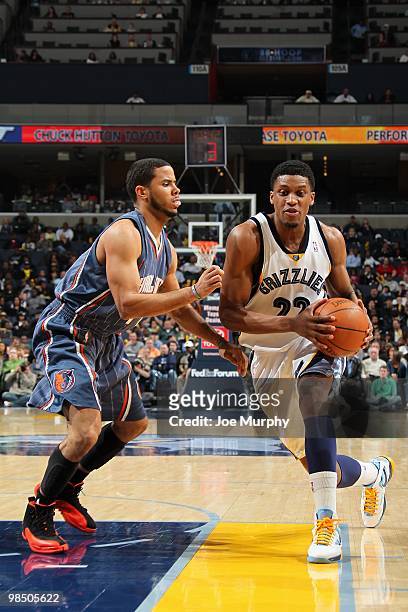 Rudy Gay of the Memphis Grizzlies moves the ball against D.J. Augustin of the Charlotte Bobcats during the game on February 26, 2010 at FedExForum in...