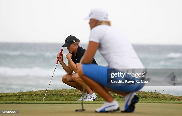 Anna Nordqvist of Sweden and Amanda Blumenherst of the United States line up their putts on the sixth green during the final match of The Mojo 6...