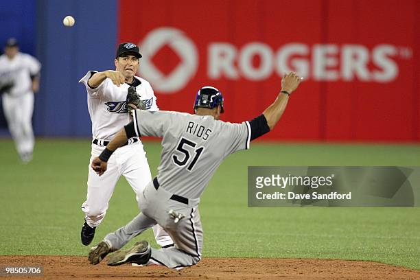 Alex Rios of the Chicago White Sox is forced out at 2nd base by John McDonald of the Toronto Blue Jays during their MLB game at the Rogers Centre...