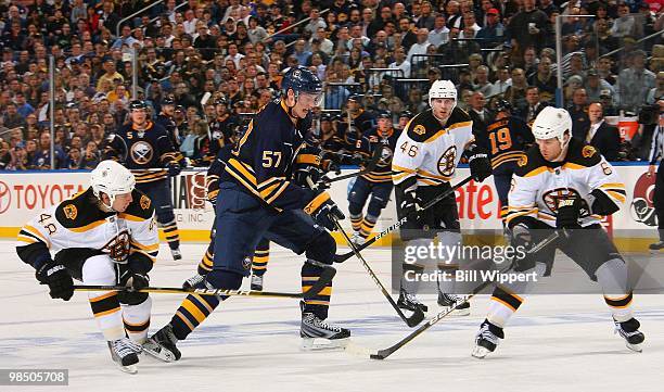 Tyler Myers of the Buffalo Sabres skates against Matt Hunwick and Dennis Wideman of the Boston Bruins in Game One of the Eastern Conference...