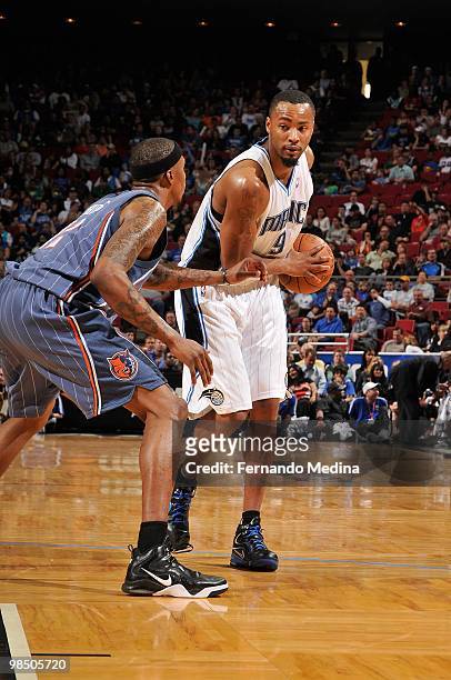 Rashard Lewis of the Orlando Magic looks to move the ball against Tyrus Thomas of the Charlotte Bobcats during the game on March 14, 2010 at Amway...