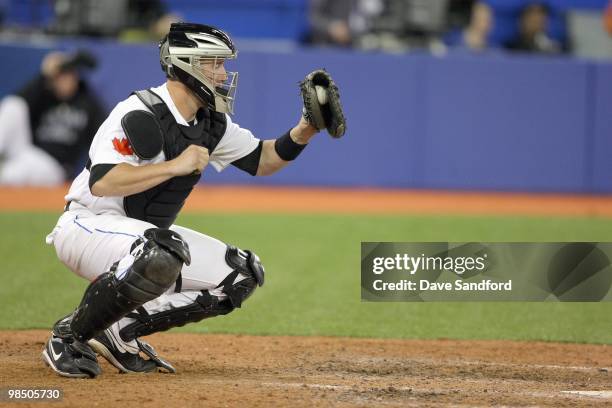 John Buck of the Toronto Blue Jays makes a catch behind the plate during the game against the Chicago White Sox at the Rogers Centre on April 12,...
