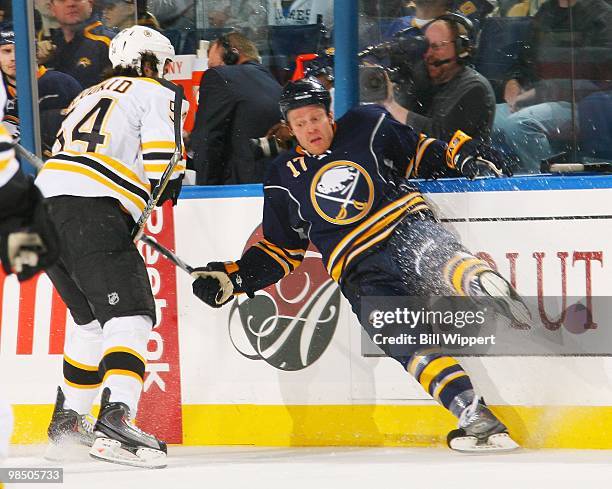Raffi Torres of the Buffalo Sabres is checked by Adam McQuaid of the Boston Bruins in Game One of the Eastern Conference Quarterfinals during the...