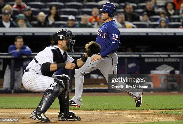 Michael Young of the Texas Rangers scores a first inning run past Francisco Cervelli of the New York Yankees on April 16, 2010 at Yankee Stadium in...