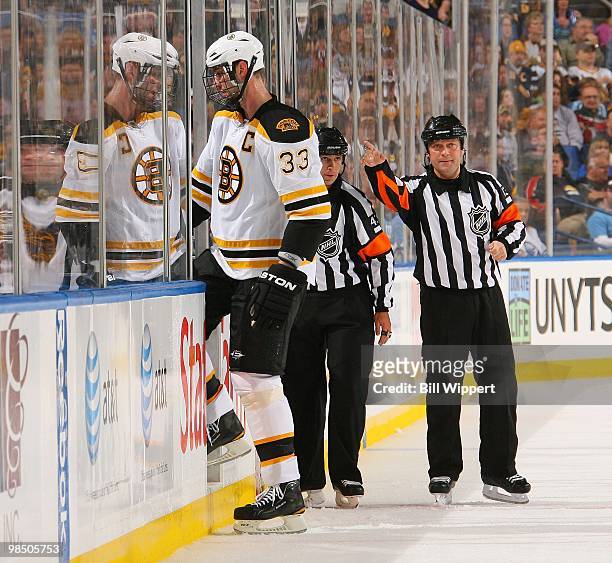 Zdeno Chara of the Boston Bruins is directed to the penalty box by referee Dan O'Halloran in their game against the Buffalo Sabres in Game One of the...